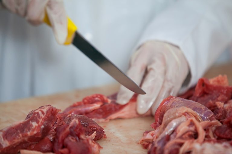 raw meat being cut